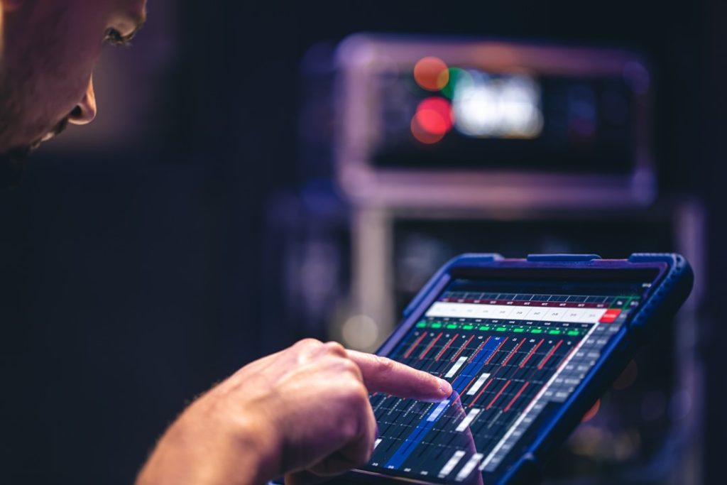 一位男士右手單指，操作平板的錄音介面